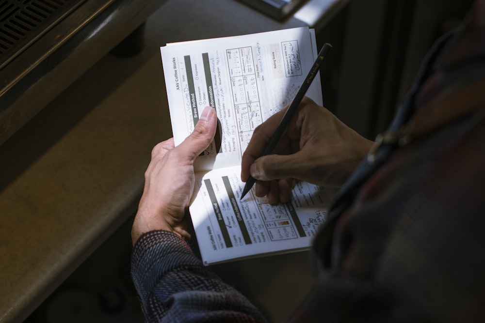 person holding white printer paper