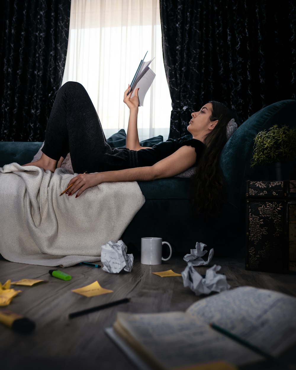 woman in black long sleeve shirt and black pants lying on black couch