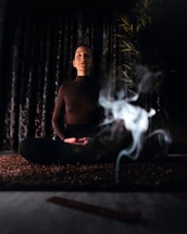 topless man sitting on bench with fire in front