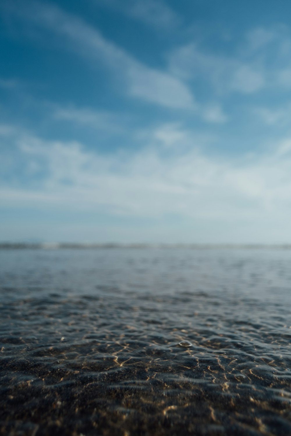 body of water under blue sky during daytime