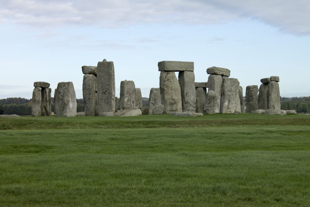 gray rock formation on green grass field during daytime