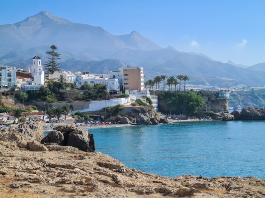 white concrete building near body of water during daytime