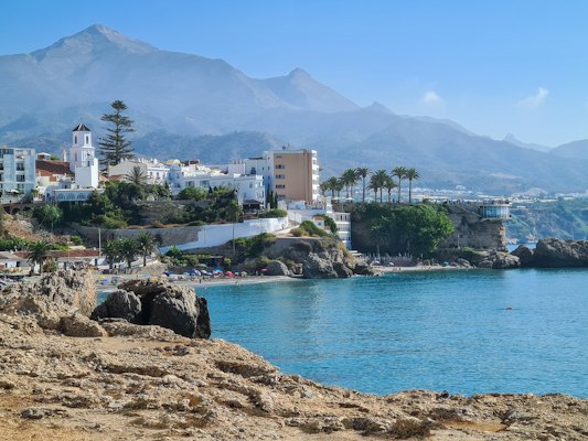 The white town along the cliffs under the mountains — Nerja, Spain