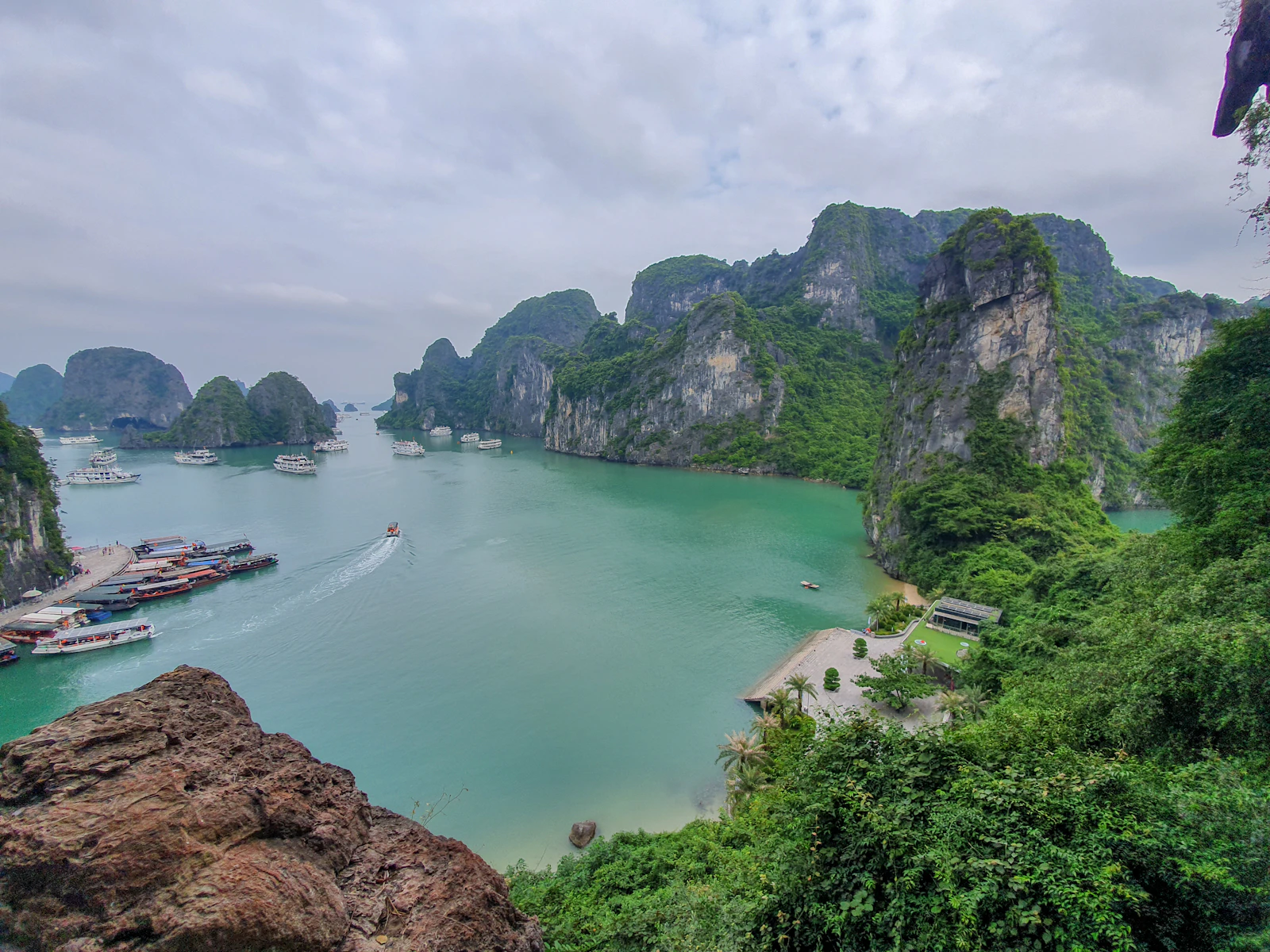 Boats among limestone formations in Ha Long Bay