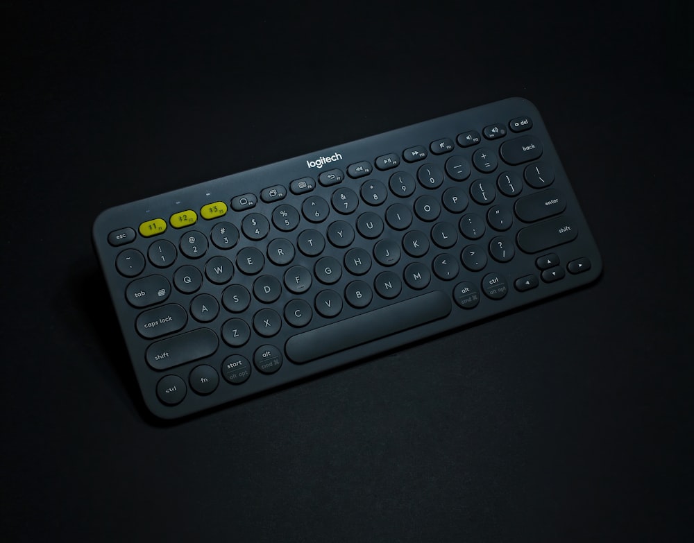 black logitech cordless keyboard on black surface