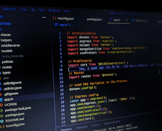 A computer screen displaying a text editor with several files open. Code is written in TypeScript or JavaScript, showing imports and configurations for a web application. The directory structure is visible on the left sidebar, highlighting different folders and files related to the project.