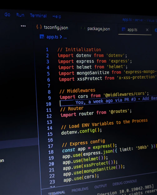 A computer screen displaying a text editor with several files open. Code is written in TypeScript or JavaScript, showing imports and configurations for a web application. The directory structure is visible on the left sidebar, highlighting different folders and files related to the project.
