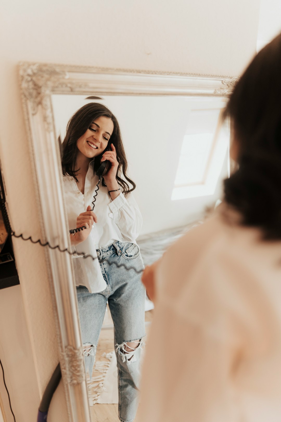 woman in white long sleeve shirt and blue denim jeans standing beside man in white dress