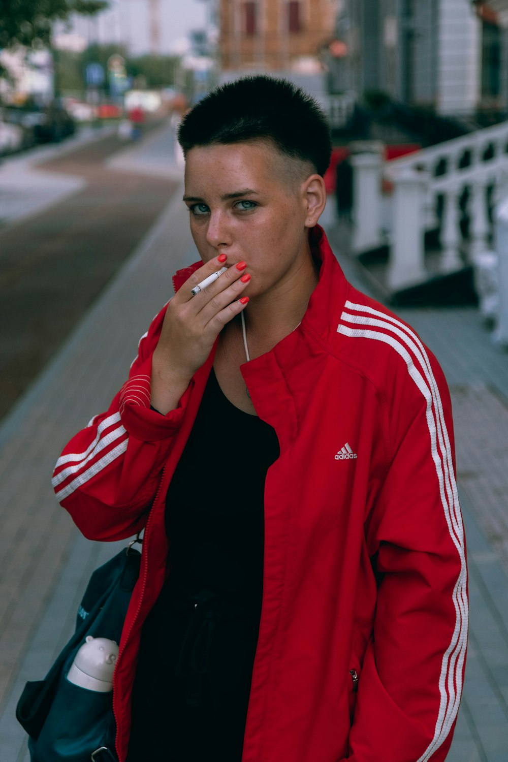 man in red and white adidas zip up jacket