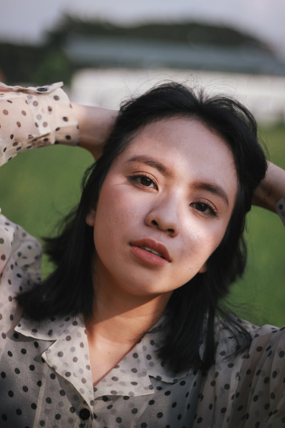 woman in white and black polka dot shirt