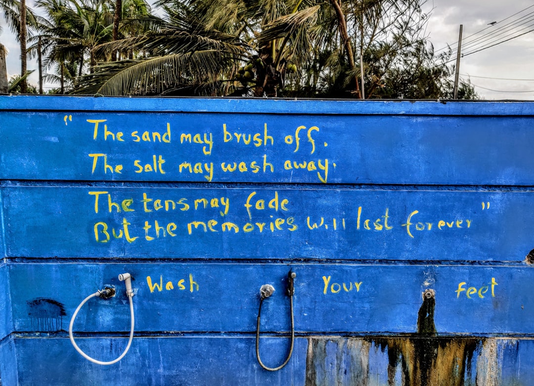 blue and white quote board, "The sand may brush off, The salt may wash away, The tans may fade, But the memories will last forever."