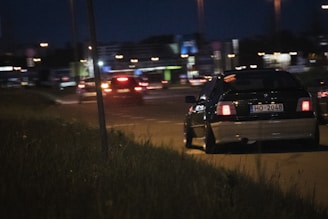 black car on road during night time