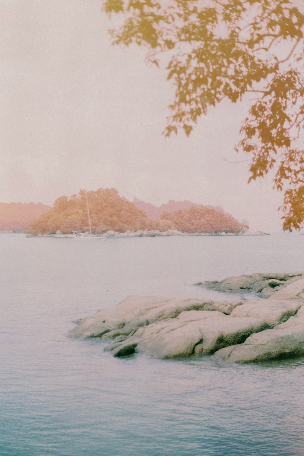 gray rock formation on body of water during daytime