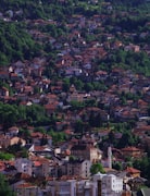 Sarajevo old town Baščaršija with the mosque minaret and Ottoman bazaar district under snowy mountains