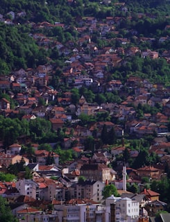 Sarajevo old town Baščaršija with the mosque minaret and Ottoman bazaar district under snowy mountains