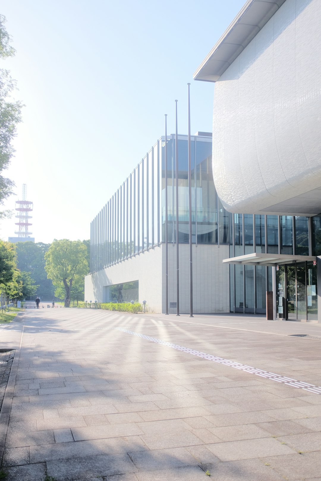 white concrete building near green trees during daytime