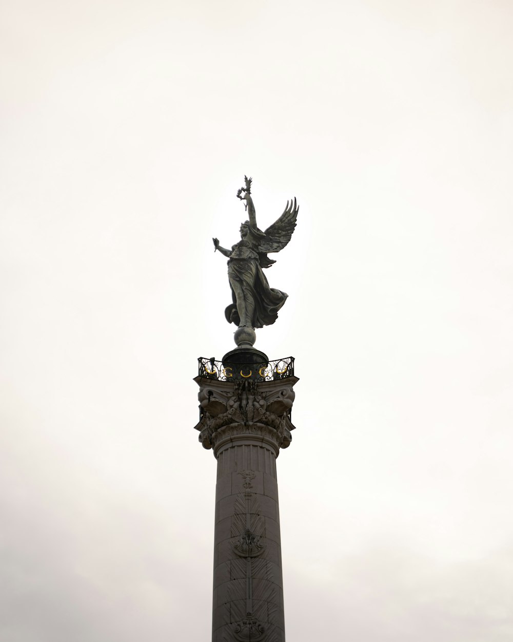 black statue of man holding book