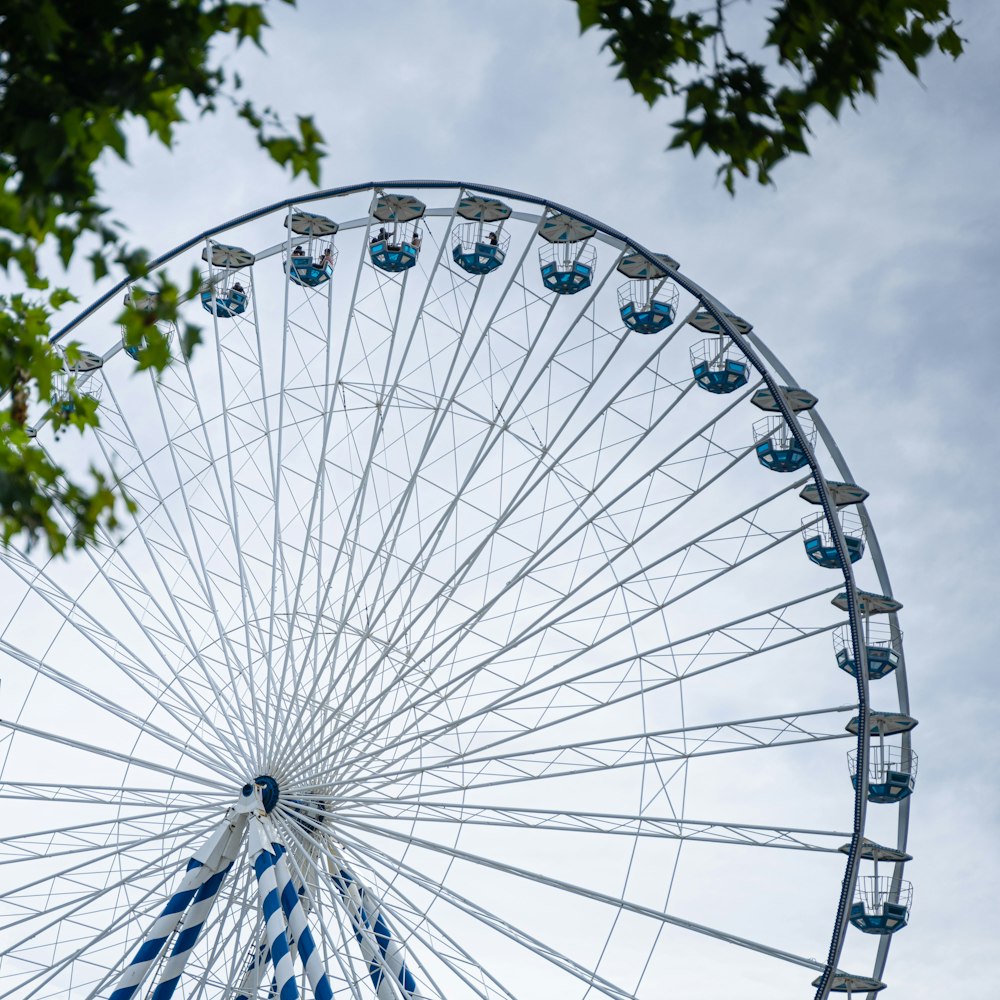 white ferris wheel under cloudy sky during daytime