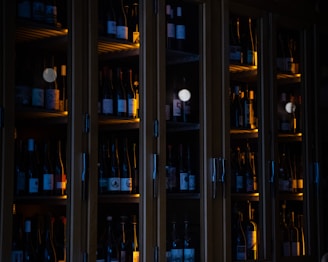 brown wooden glass cabinet with bottles