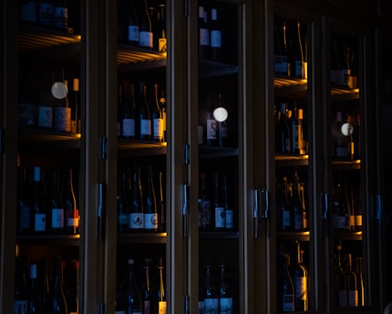 brown wooden glass cabinet with bottles