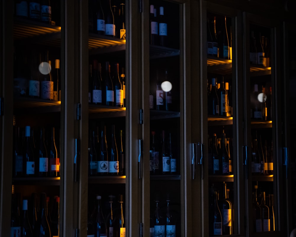 brown wooden glass cabinet with bottles