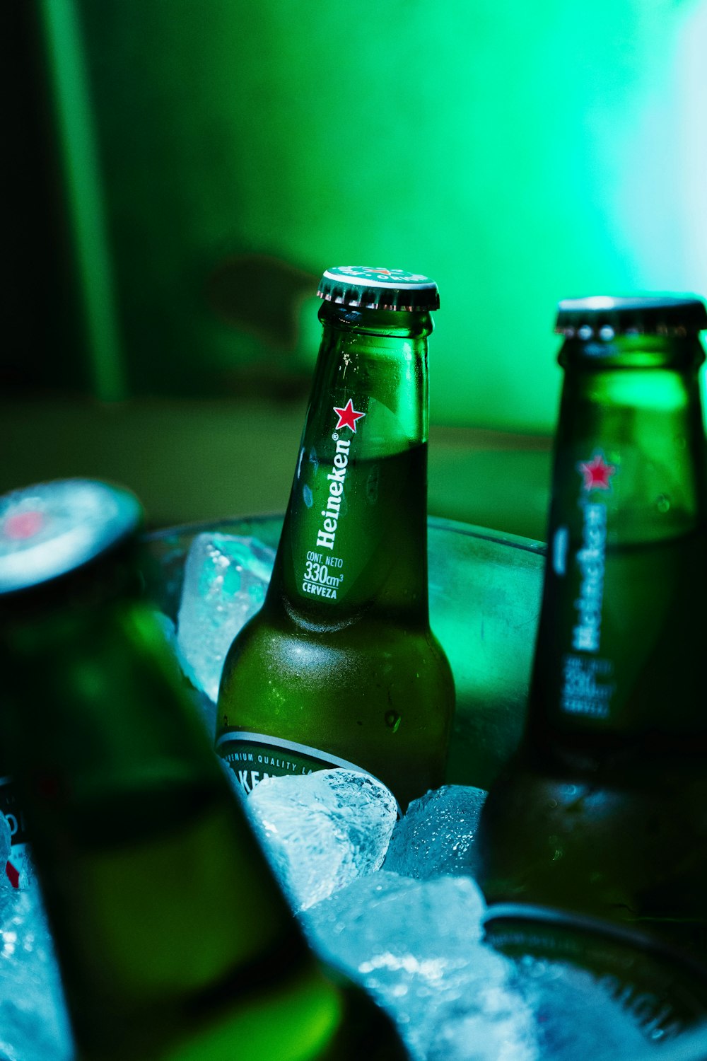 green glass bottle on gray concrete surface