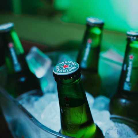 green glass bottle on stainless steel tray