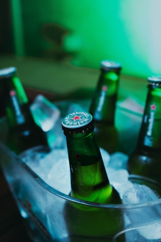 green glass bottle on stainless steel tray