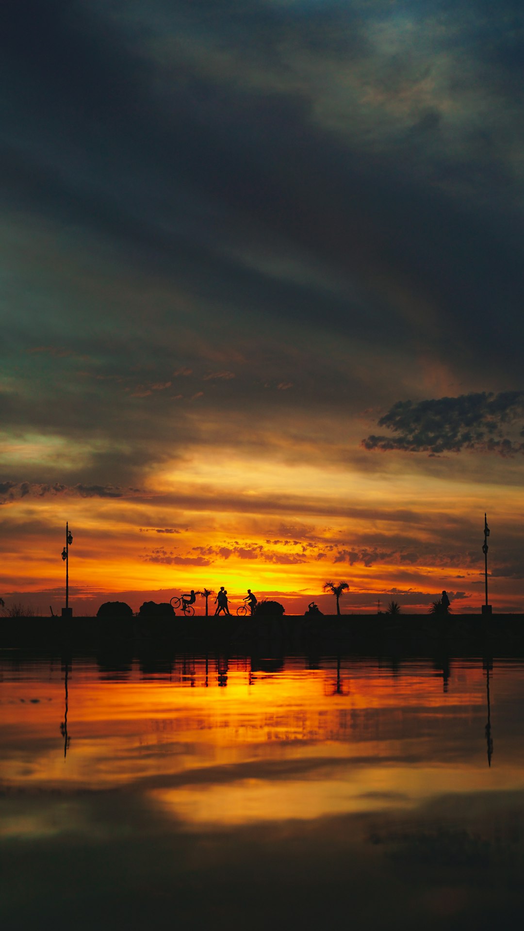 silhouette of people on beach during sunset