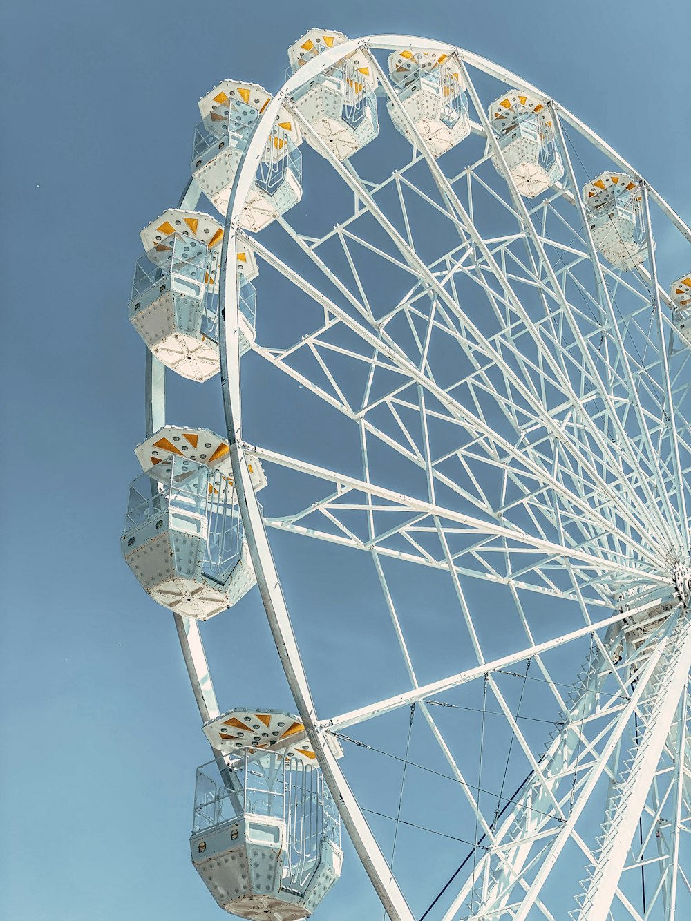 a large white ferris wheel against a blue sky