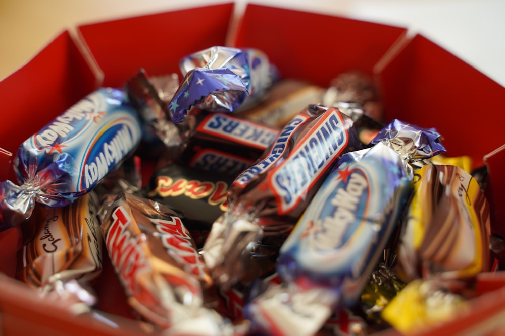 assorted chocolate bar on red shelf