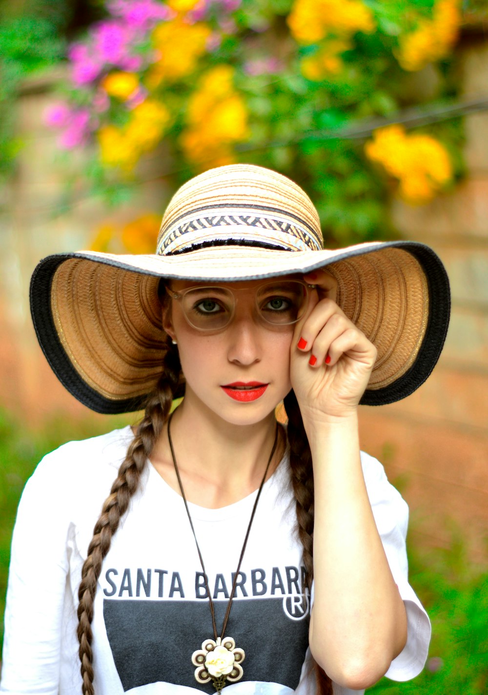 woman in white shirt wearing brown straw hat