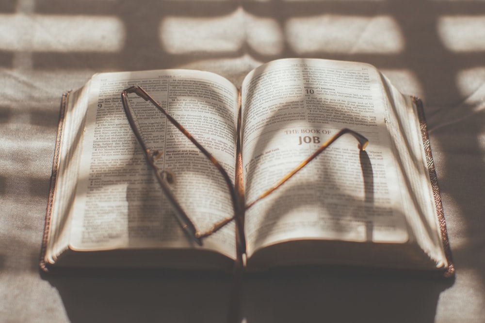 black framed eyeglasses on white book page