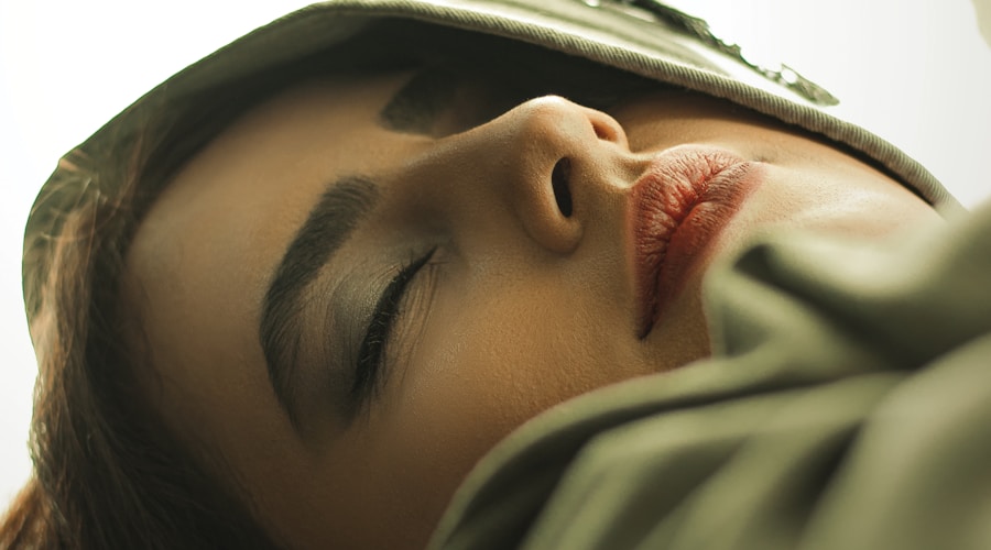 woman in gray hoodie covering her face with gray textile