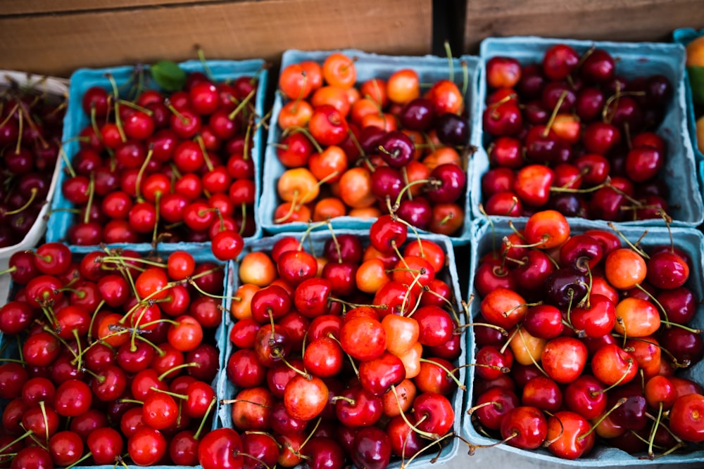 red cherries on brown wooden crate