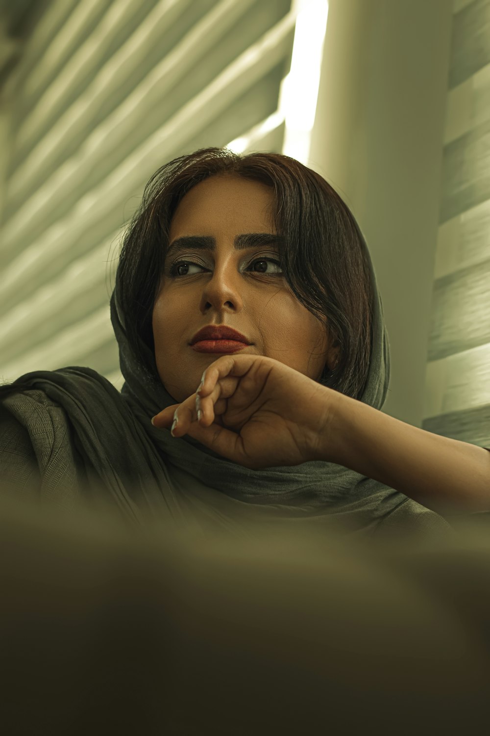 woman in black shirt with red manicure