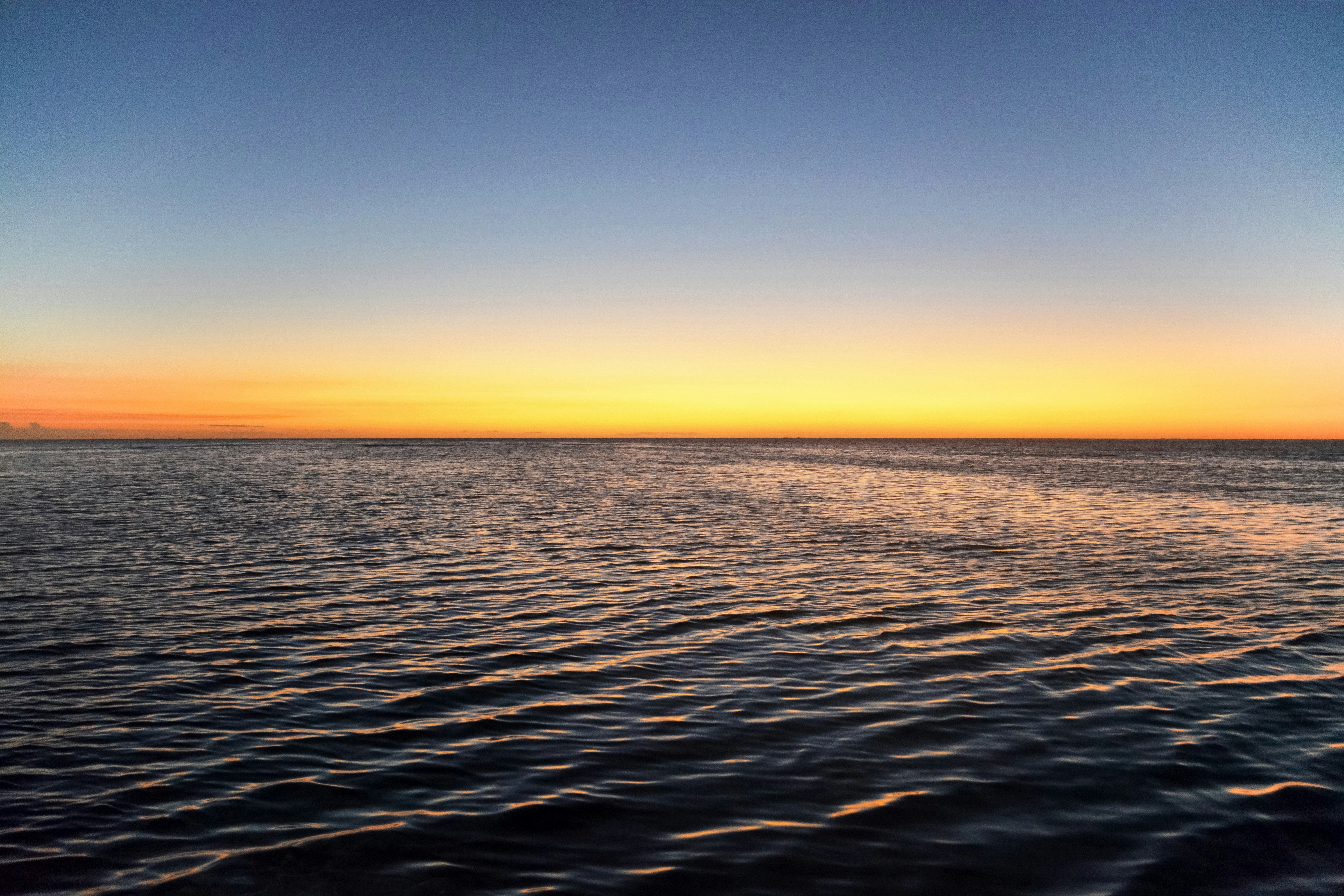 body of water during sunset