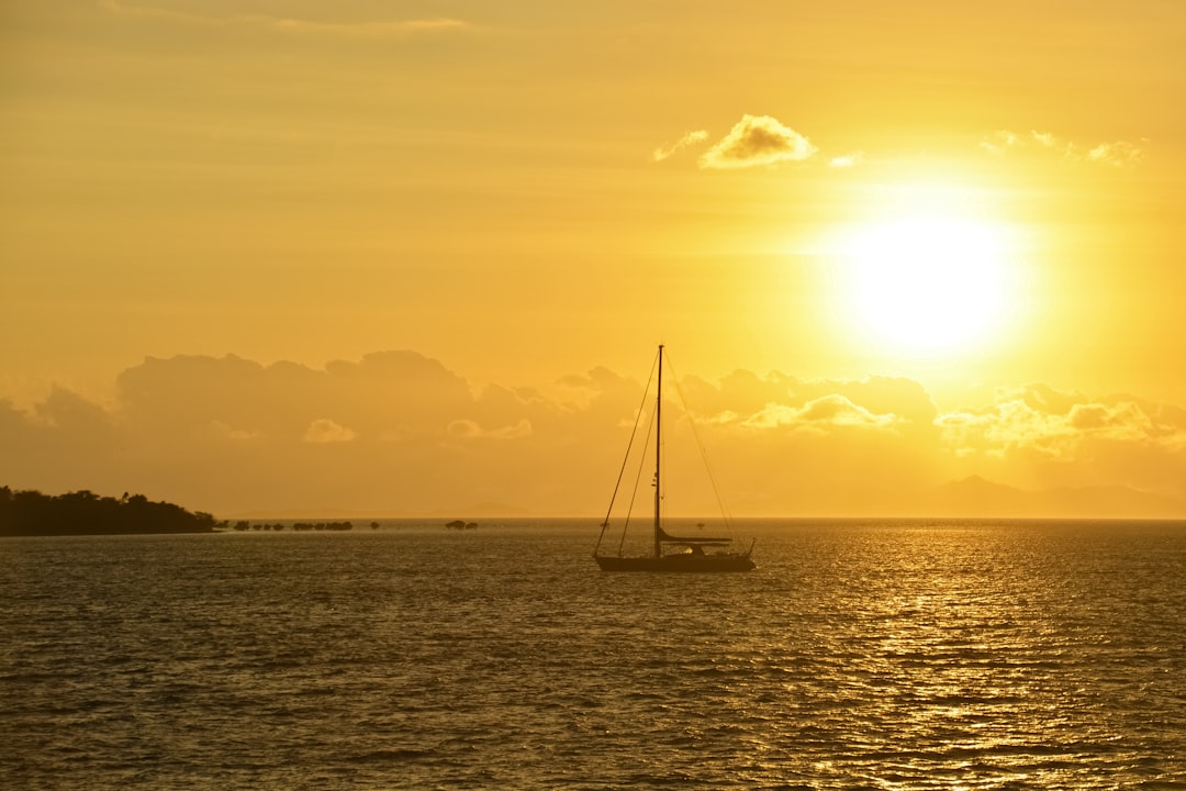 sailboat on sea during sunset