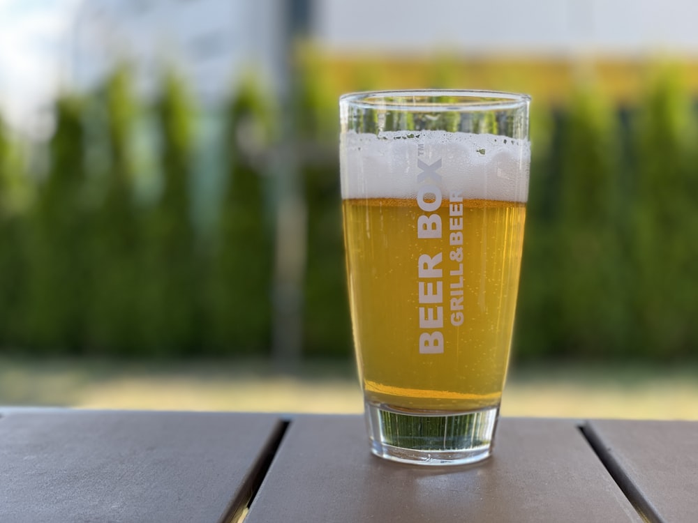 clear drinking glass with beer on table