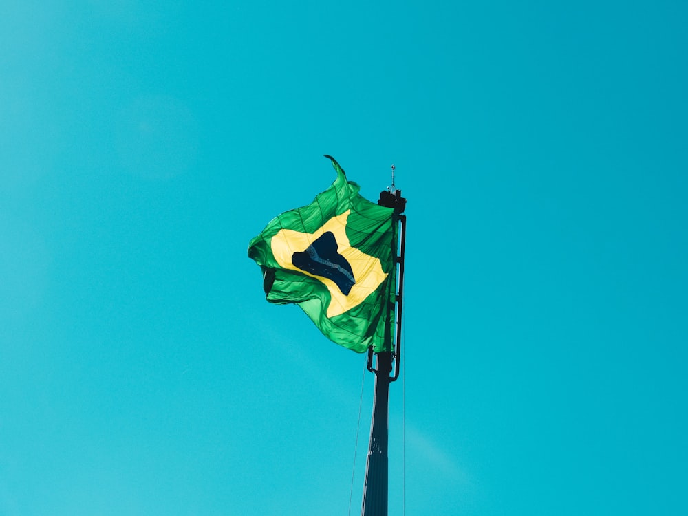 green and white flag under blue sky during daytime