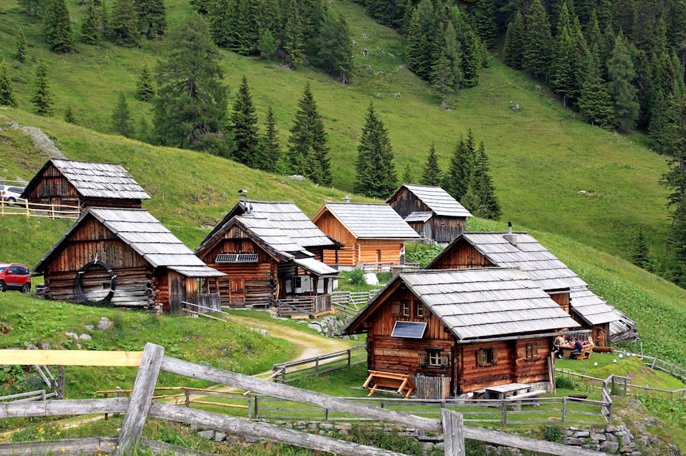 brown wooden house on green grass field during daytime