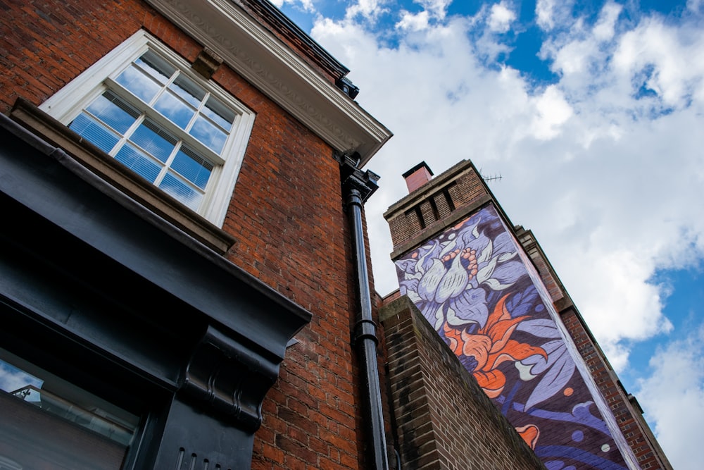 brown brick building with white and brown wall art