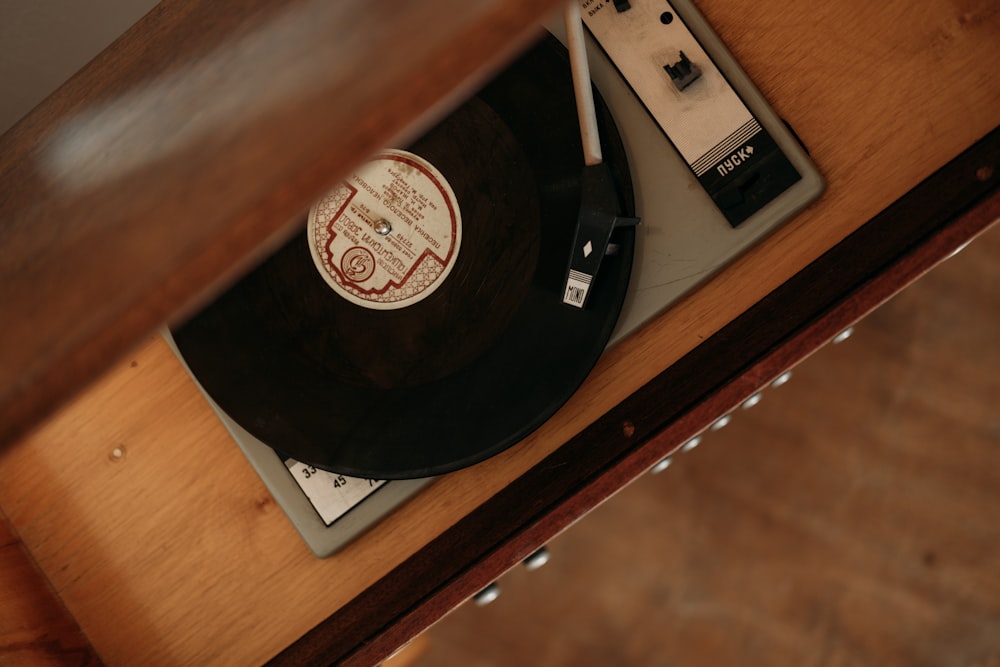 black vinyl record on brown wooden table
