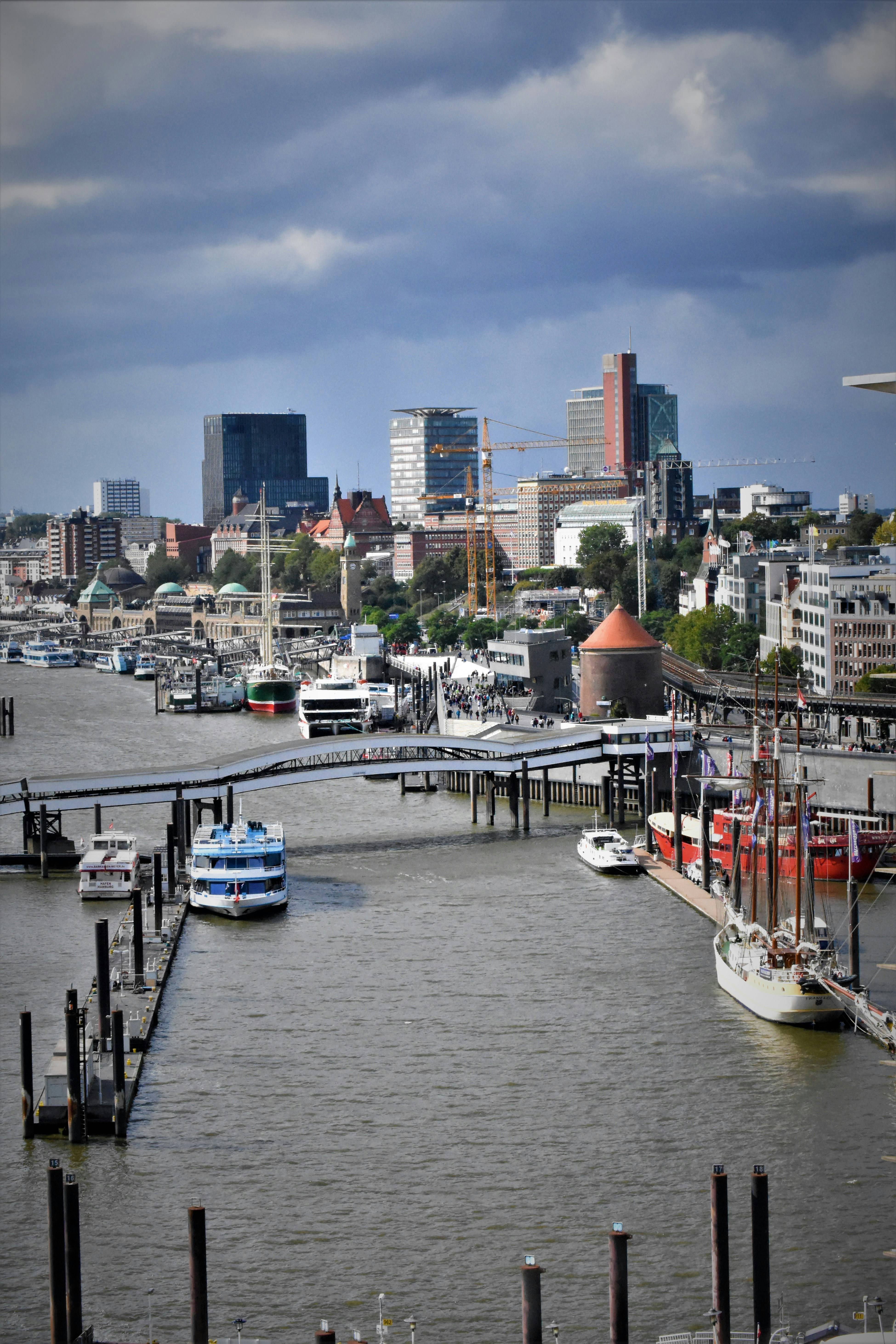 white and blue boat on dock during daytime