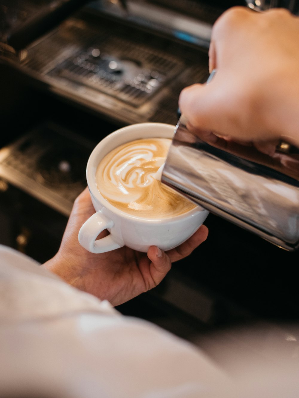 person holding white ceramic mug with coffee