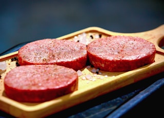 brown bread with red sauce on brown wooden tray