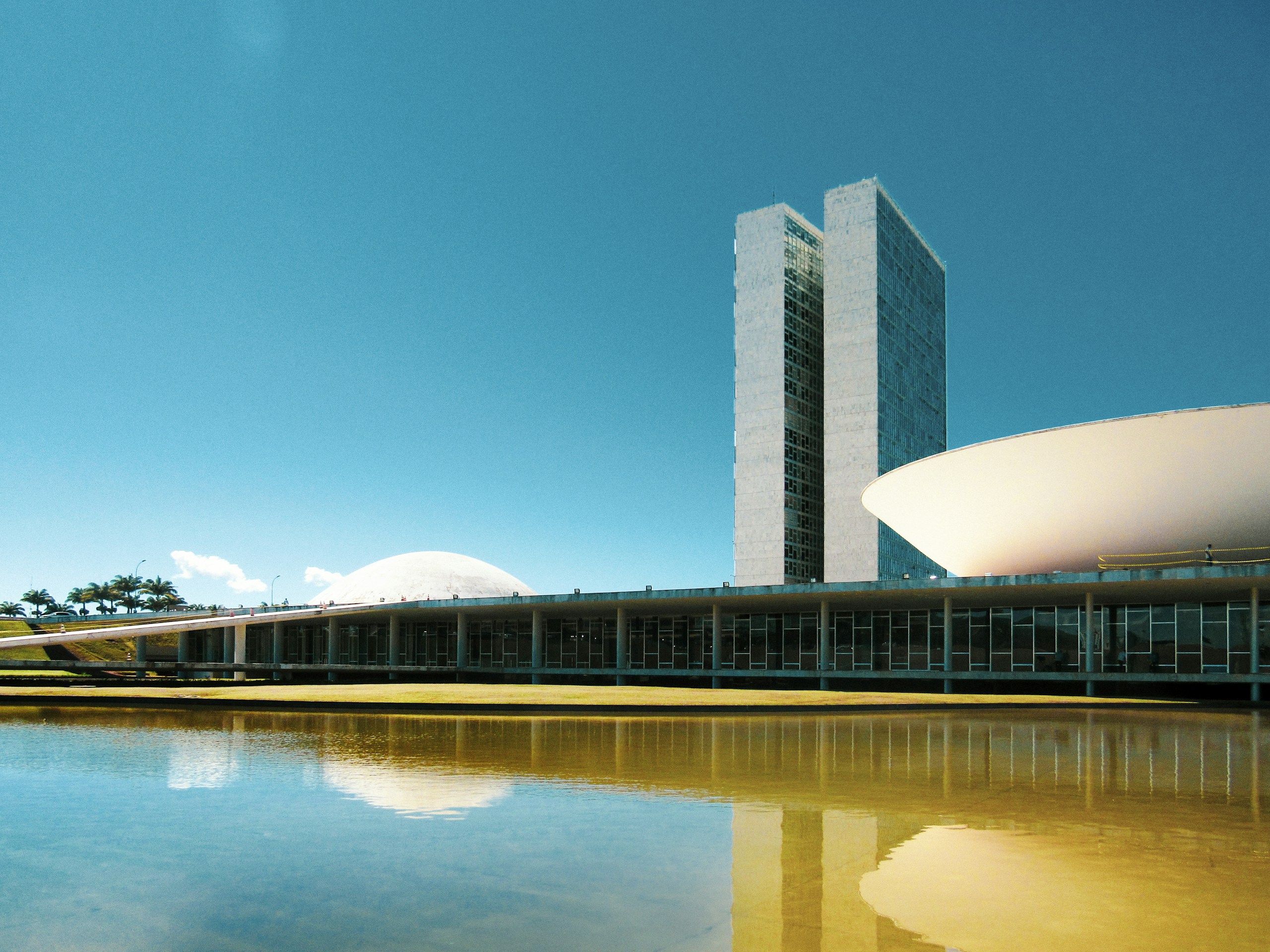 white concrete building near body of water during daytime