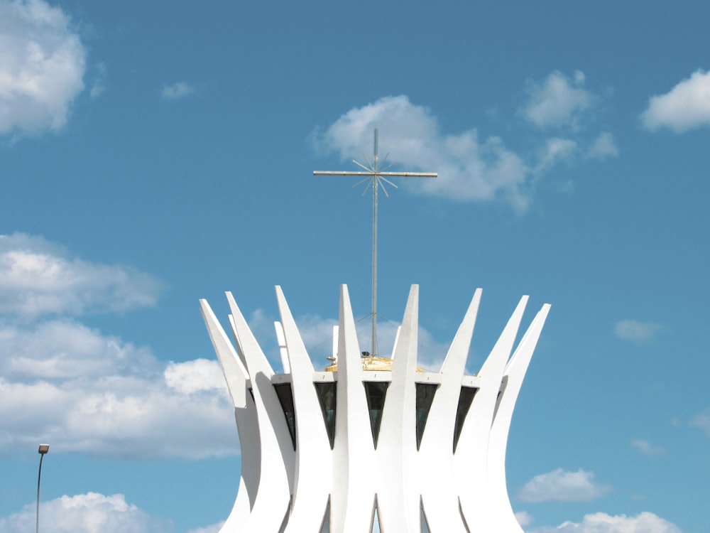 white metal cross under blue sky during daytime