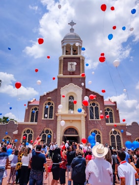 people in front of brown and white cathedral under cloudy sky during daytime