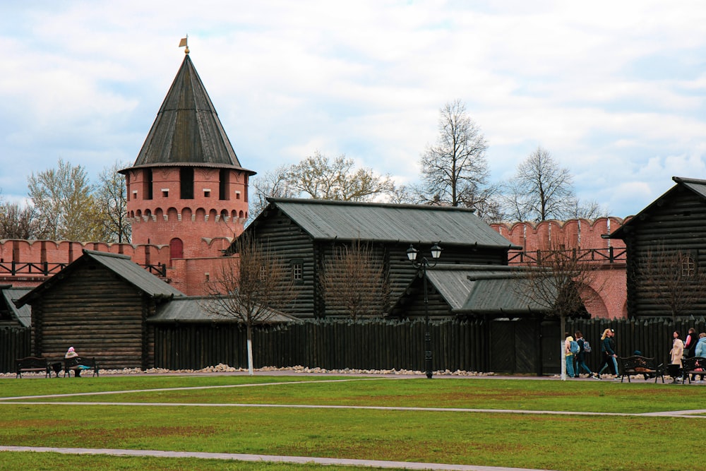 a group of people standing in front of a wooden building